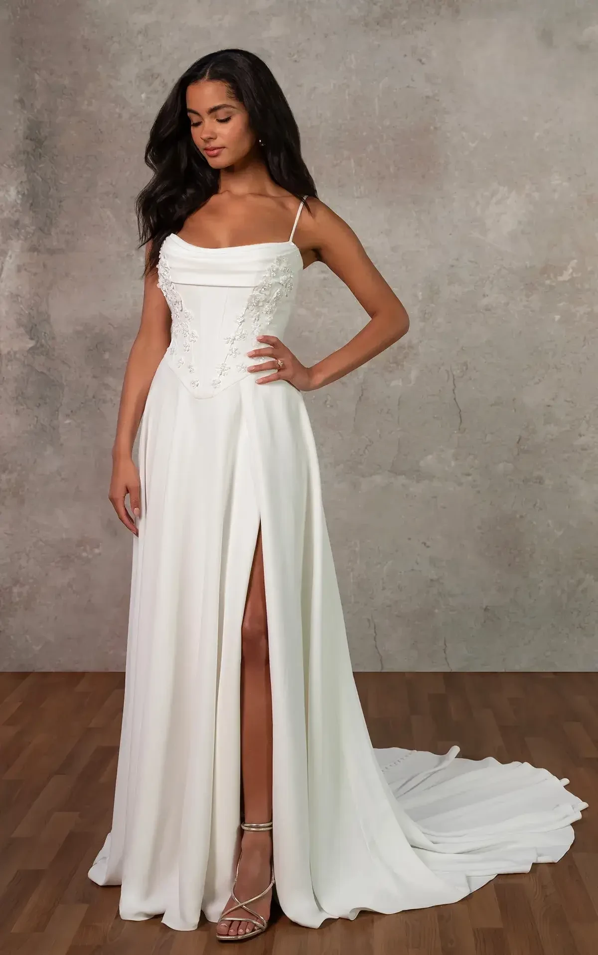 model is wearing a sleeveless sheath wedding dress