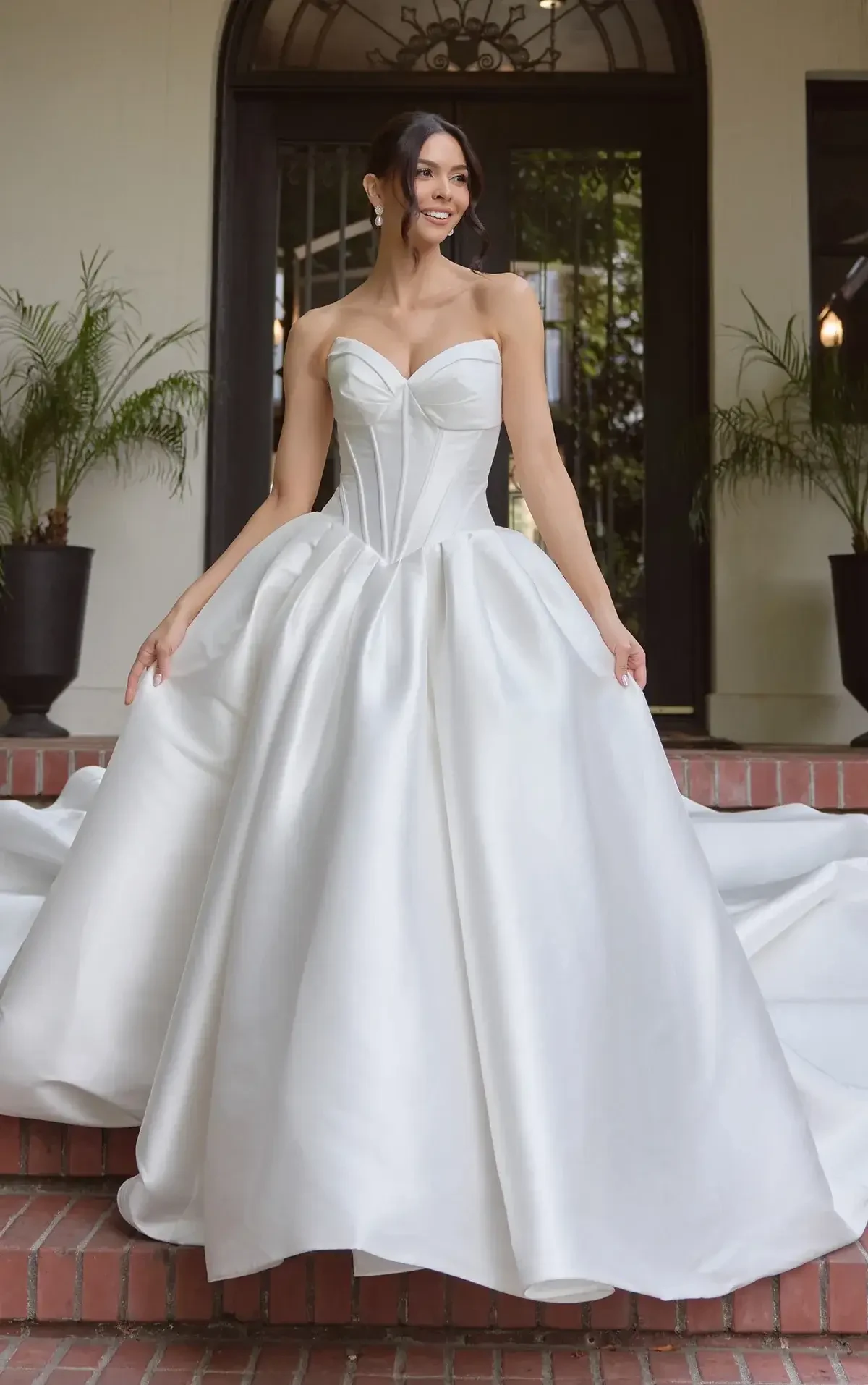 model is wearing a strapless basque waist wedding gown