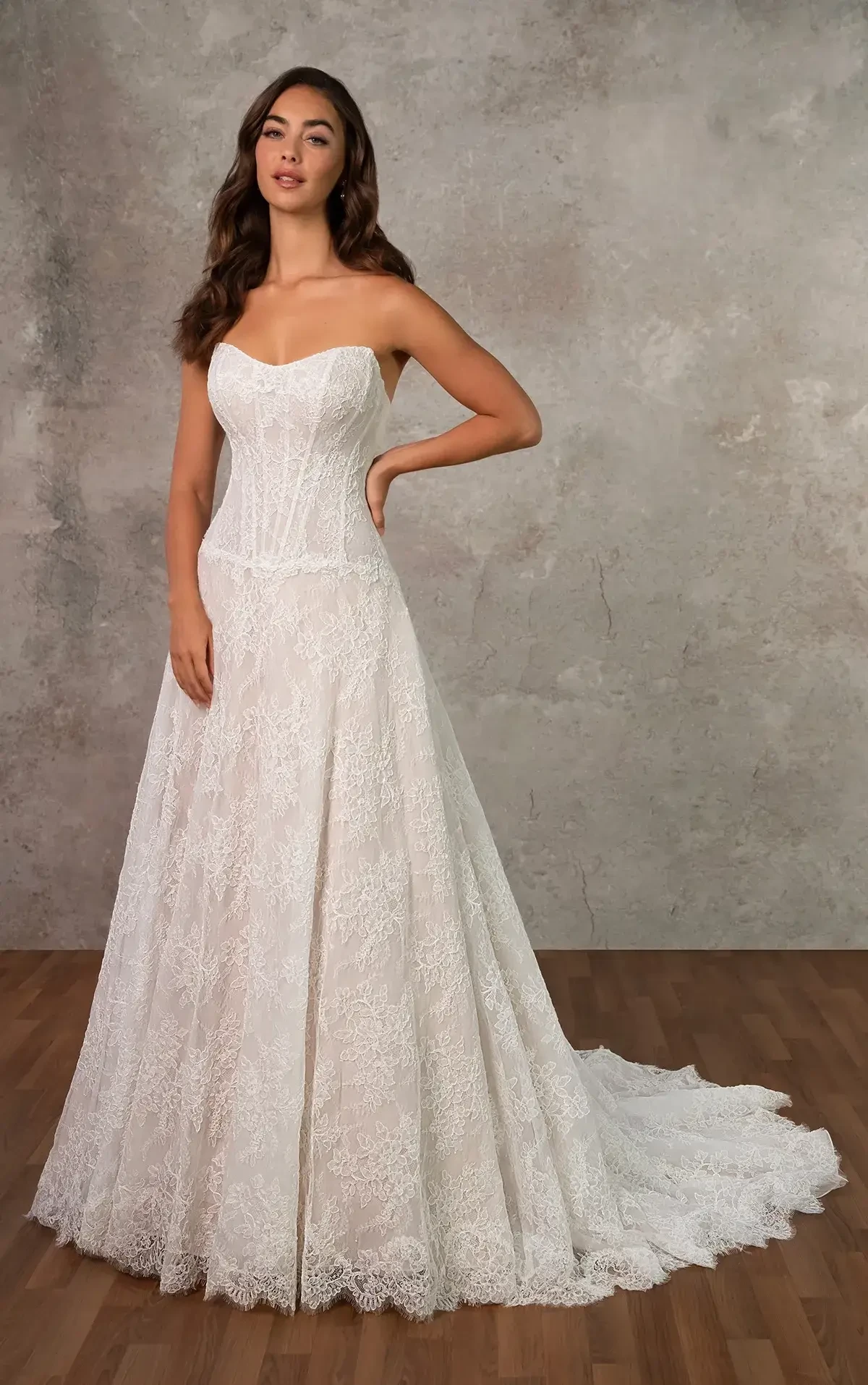 model is wearing a strapless scoop neck a-line wedding dress