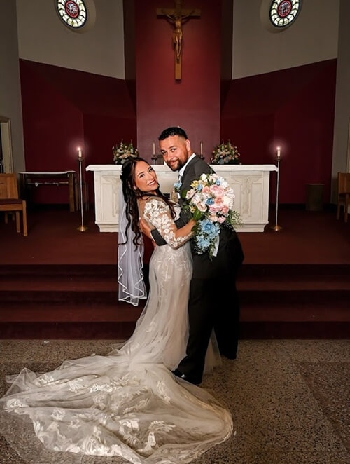 Сouple wearing a white gown and a black suit
